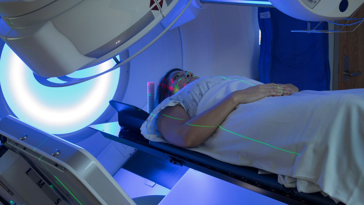 A woman under a radiotherapy machine in hospital