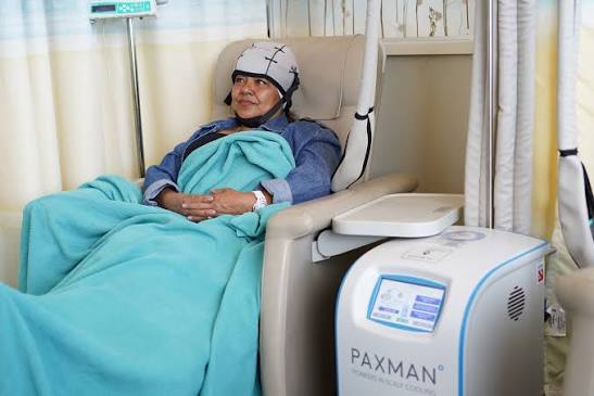 A woman using the chemo cold cap