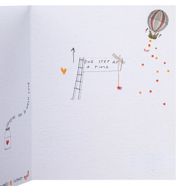 Illustrated page with a hot air balloon, ladder, and heart symbols on a white background.