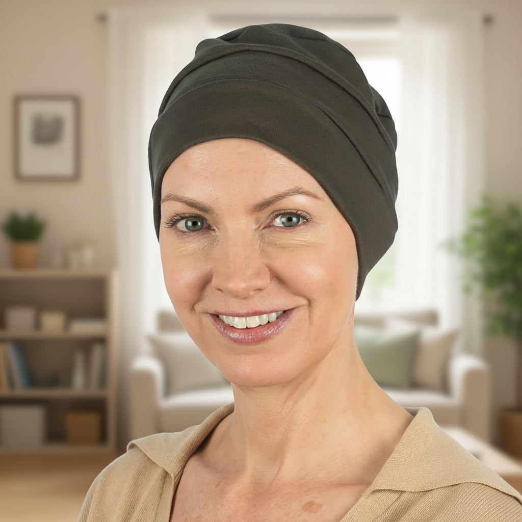 Woman wearing a brown chemo hat for cancer patients in a home setting